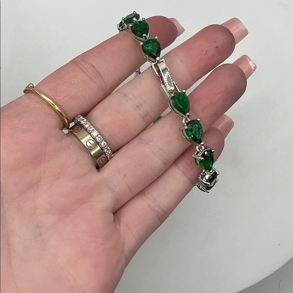 198. White Gold Plated Bracelet with Pear Shaped Emeralds 7”